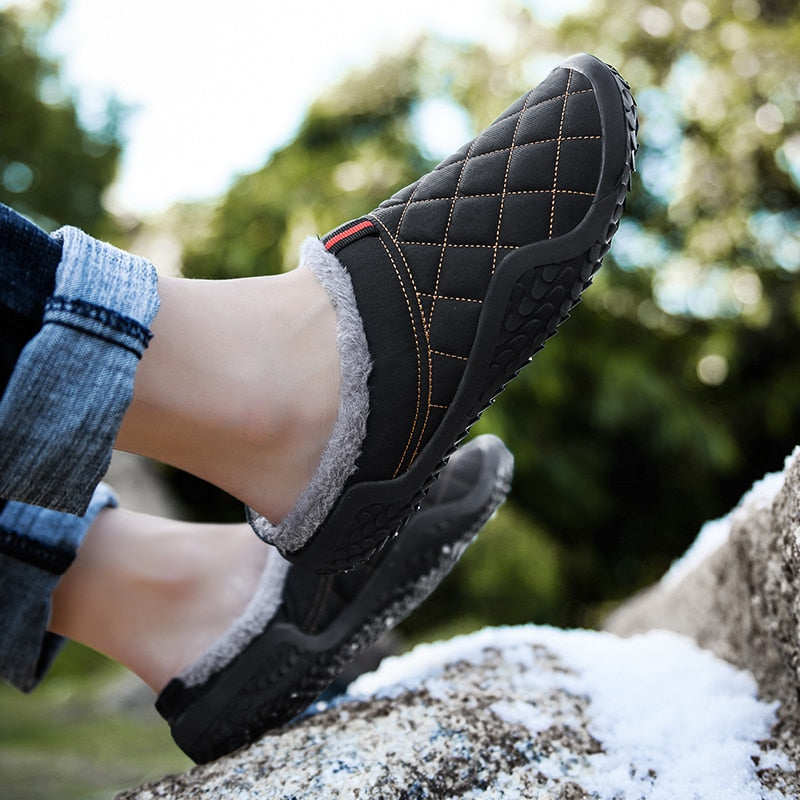 Warm and stylish, these men's slippers are perfect for winter days. The cozy lining keeps feet dry and comfortable, and the rubbery soles provide a sure footing for any day. The lightweight design adds style and comfort to any casual outfit. This pair is crafted from durable canvas material with a plushily cushioned insole. A secure constricting band around the ankle keeps the slippers securely in place. This pair is a fun and comfortable way to keep warm and stylish.