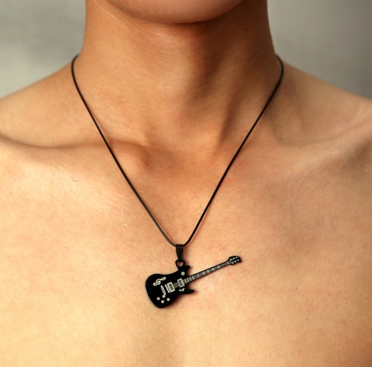 The perfect accessory for any music fan. This stainless steel guitar necklace is the perfect way to show off your musical obsession. This stainless steel guitar pendant is a sleek and stylish piece that can be worn casually or formally. This unique design is sure to turn heads. The chain is made from a soft leather that feels great against the skin. The chain is flexible so it can be worn around the neck or draped across the chest. This is a great gift for rock and roll fans and music lovers.